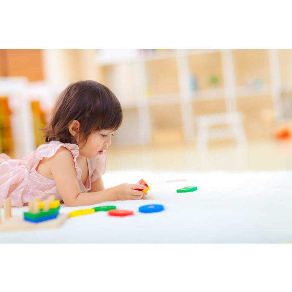 Kid playing PlanToys Geometric Sorting Board