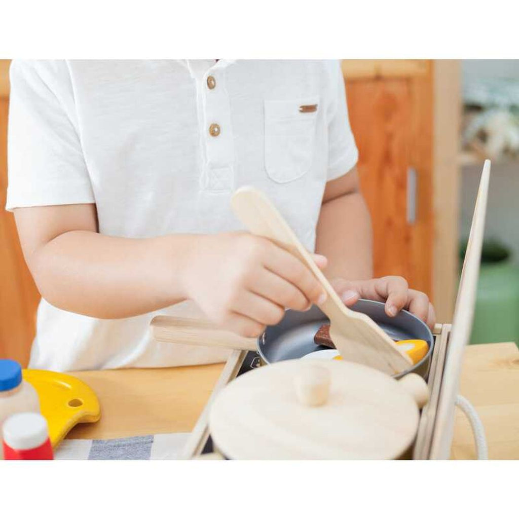 Kid playing PlanToys Cooking Utensils Set