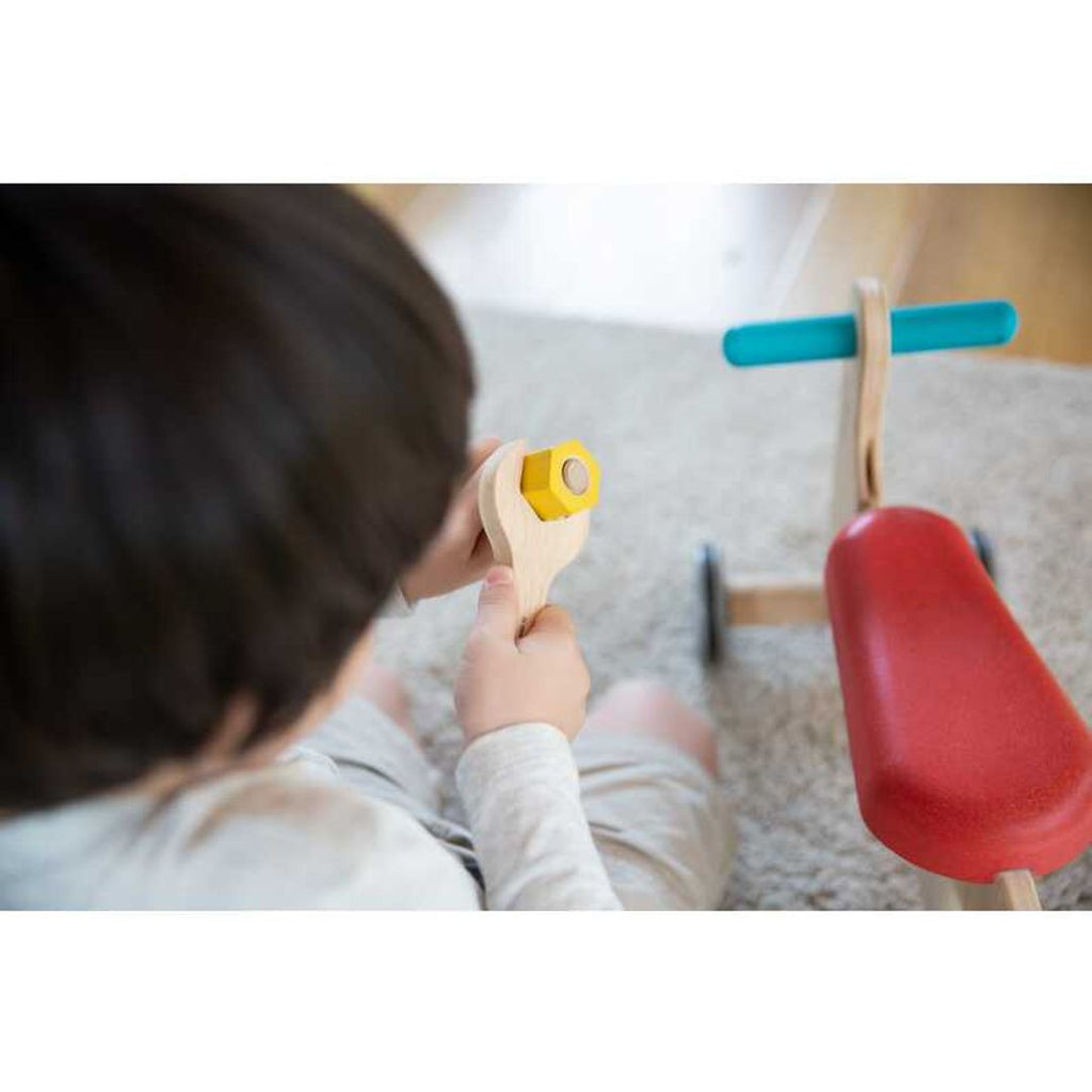 Kid playing PlanToys Tool Belt