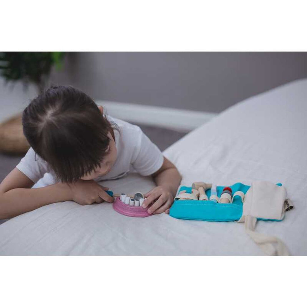 Kid playing PlanToys Dentist Set