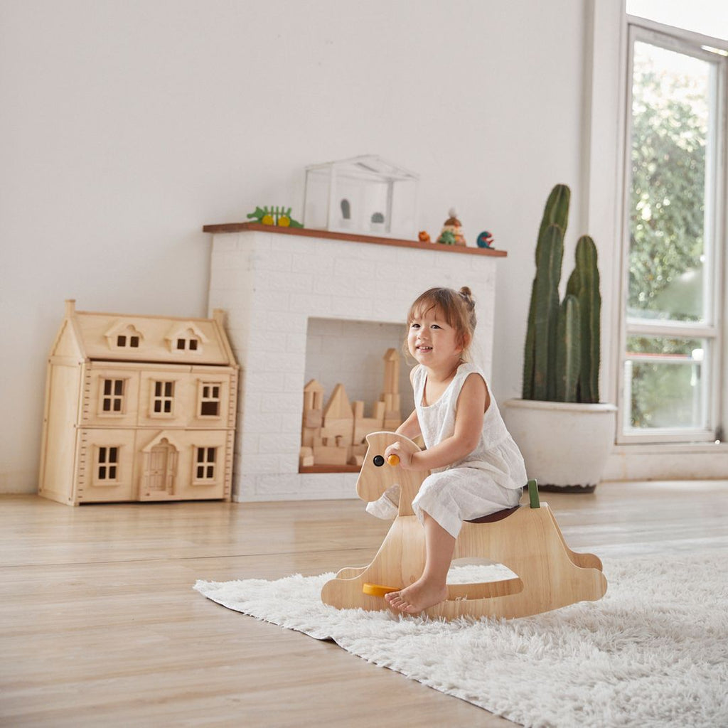 Kid playing PlanToys Palomino - Modern Rustic