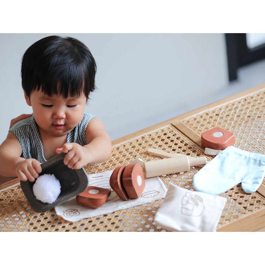 Kid playing PlanToys Bread Loaf Set