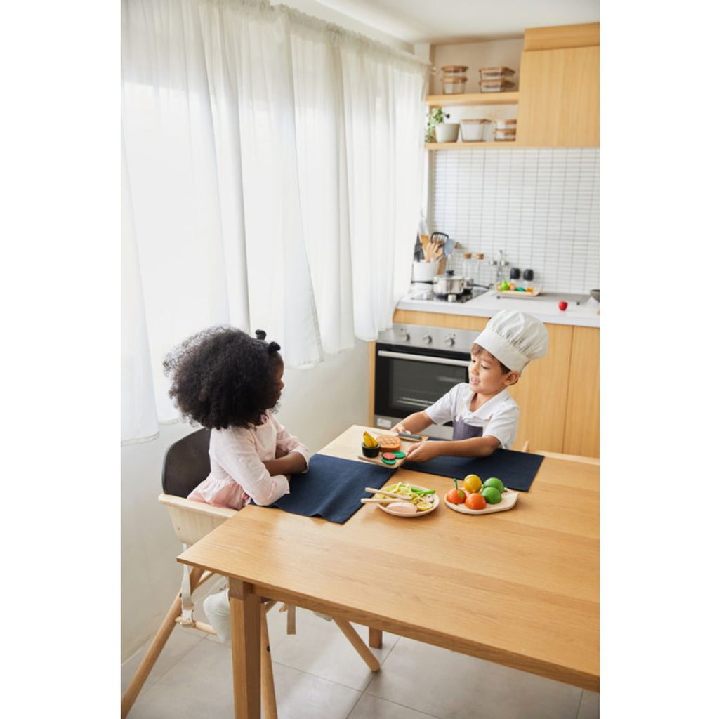 Kid playing PlanToys Steak Set