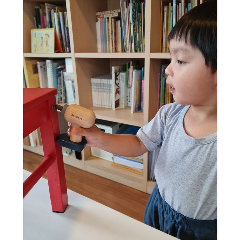 Kid playing PlanToys Handy Carpenter Set