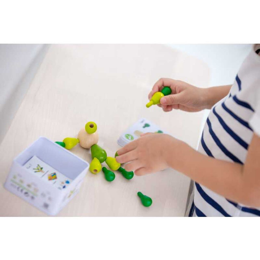 Kid playing PlanToys Balancing Cactus