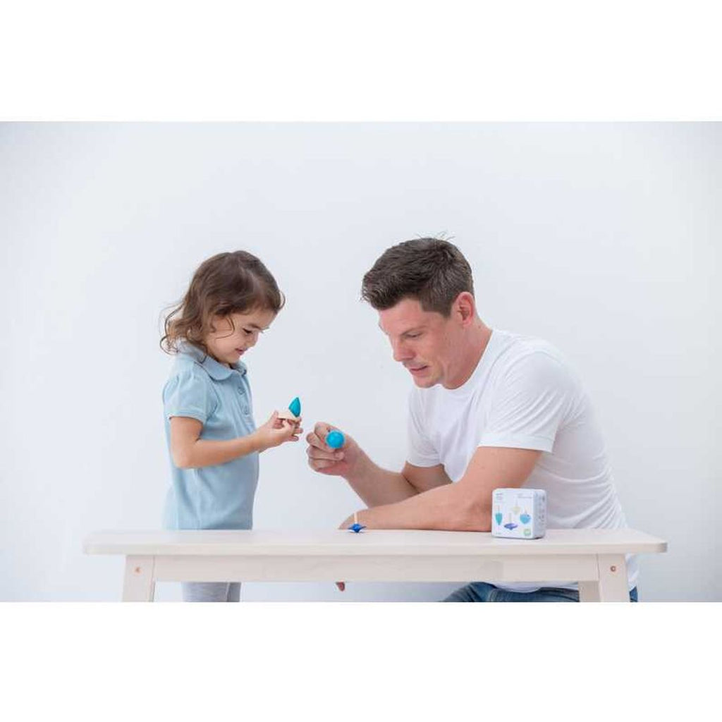 Kid playing PlanToys Spinning Tops