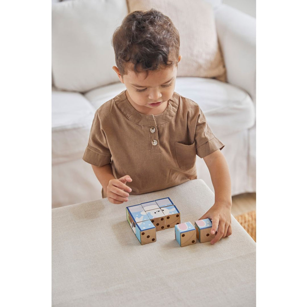 Kid playing PlanToys Animal Puzzle Cubes