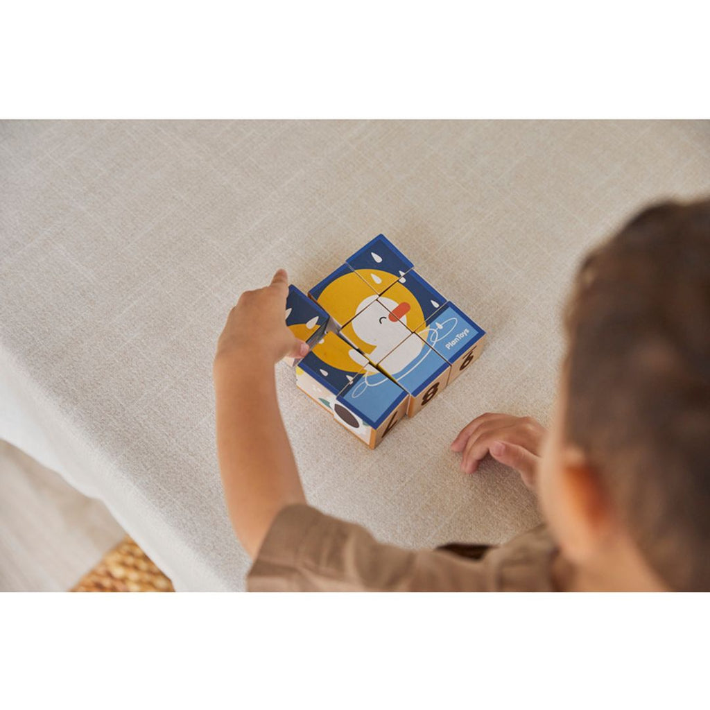 Kid playing PlanToys Animal Puzzle Cubes