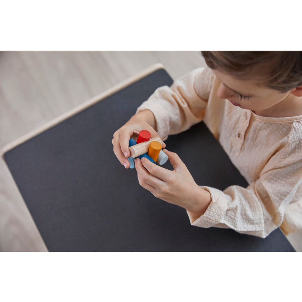 Kid playing PlanToys Log Puzzle