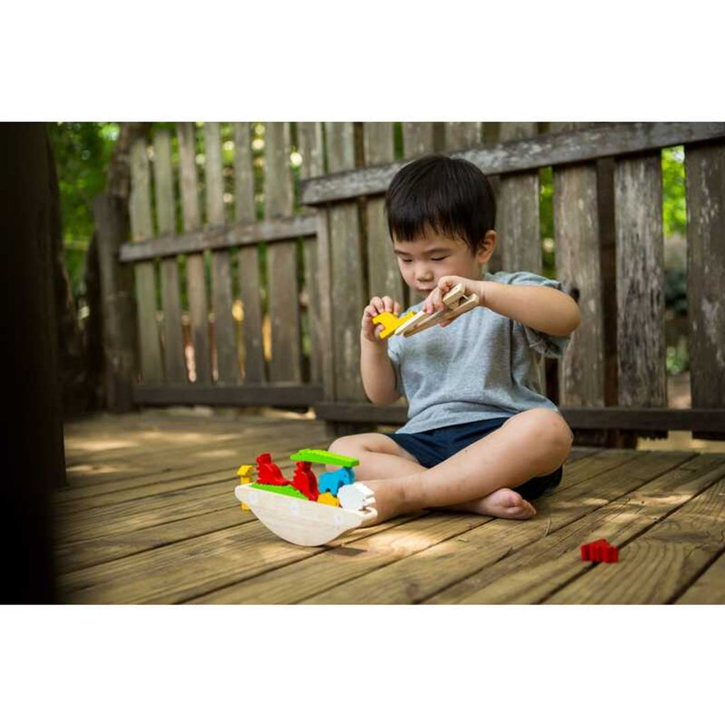 Kid playing PlanToys Balancing Boat