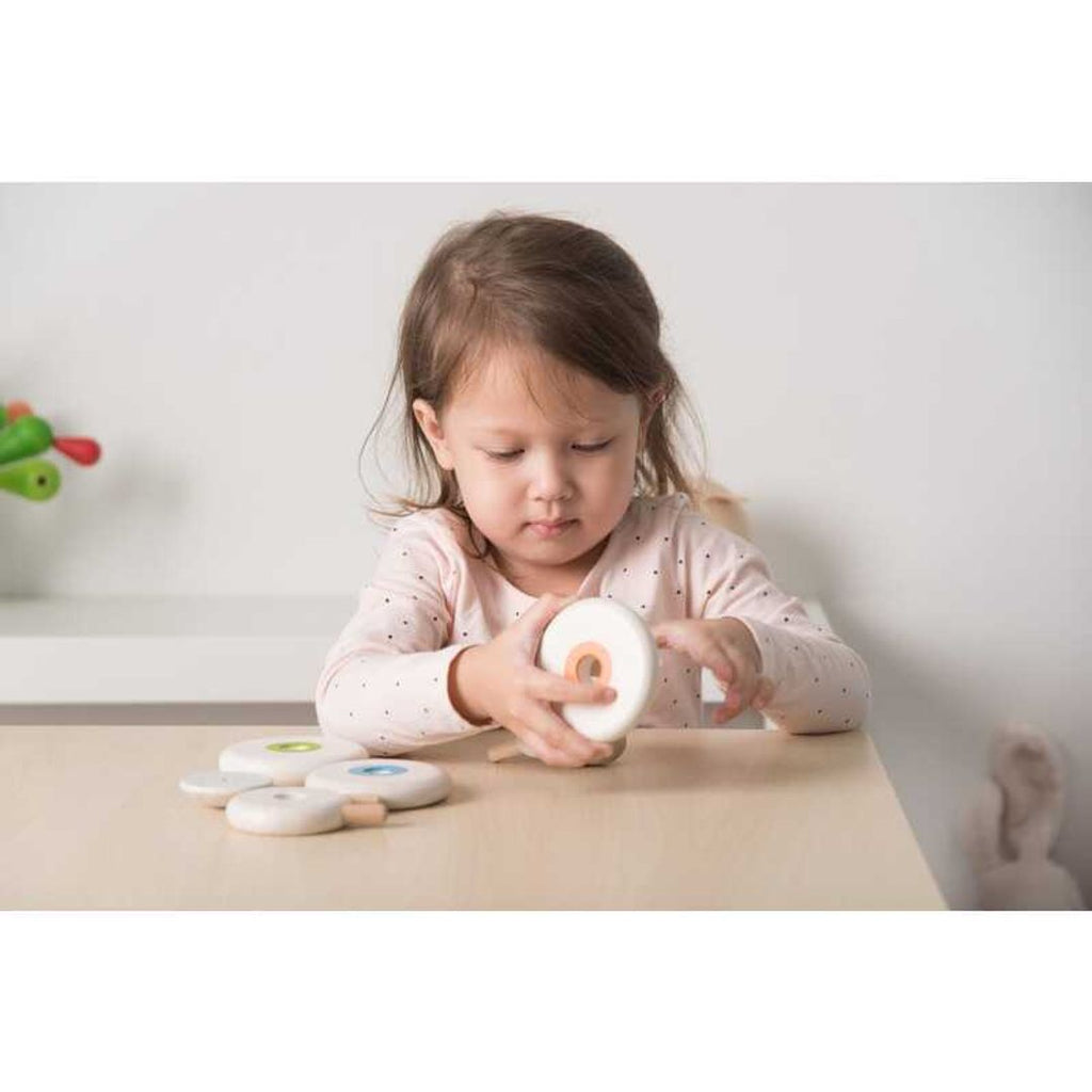 Kid playing PlanToys Lacing Sheep