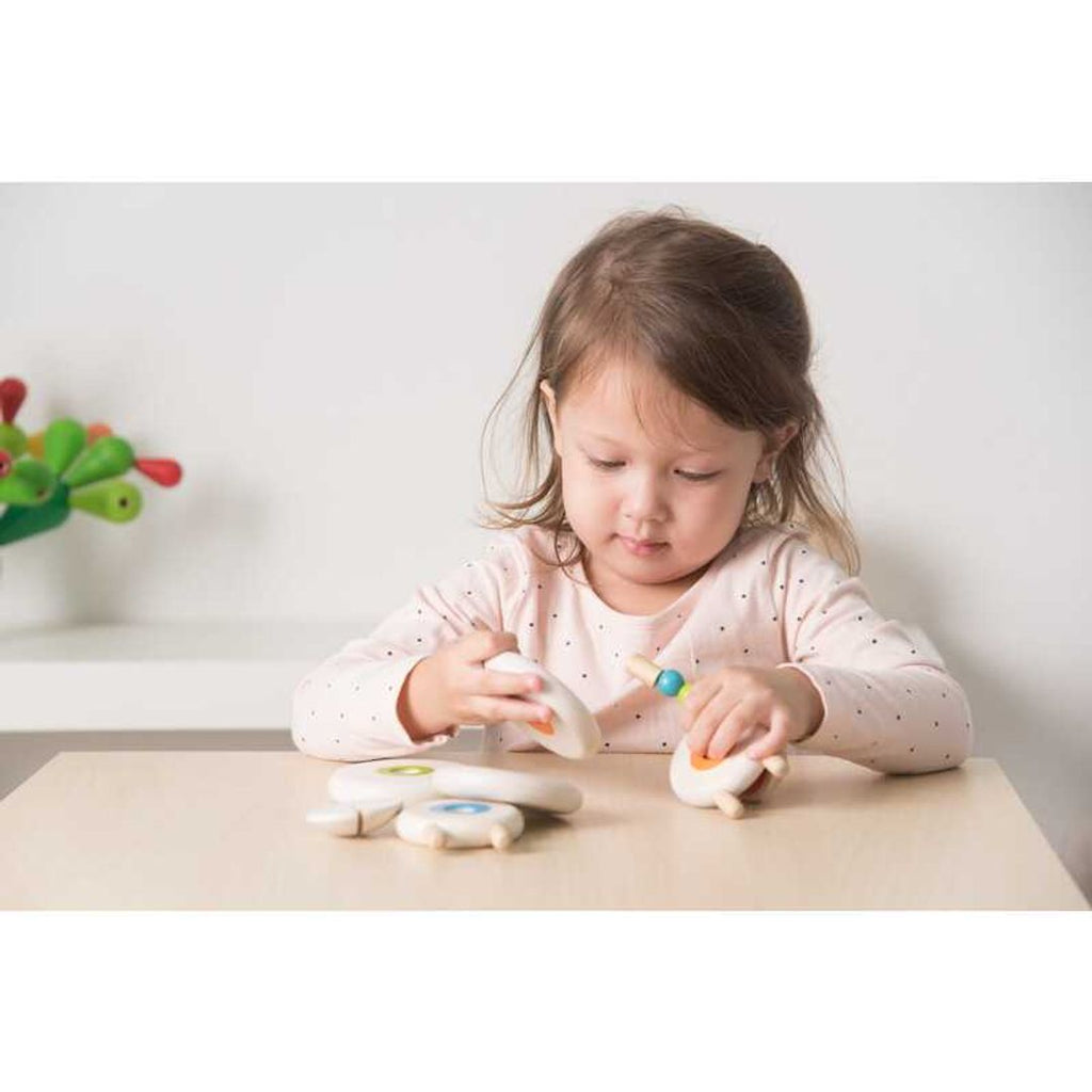 Kid playing PlanToys Lacing Sheep