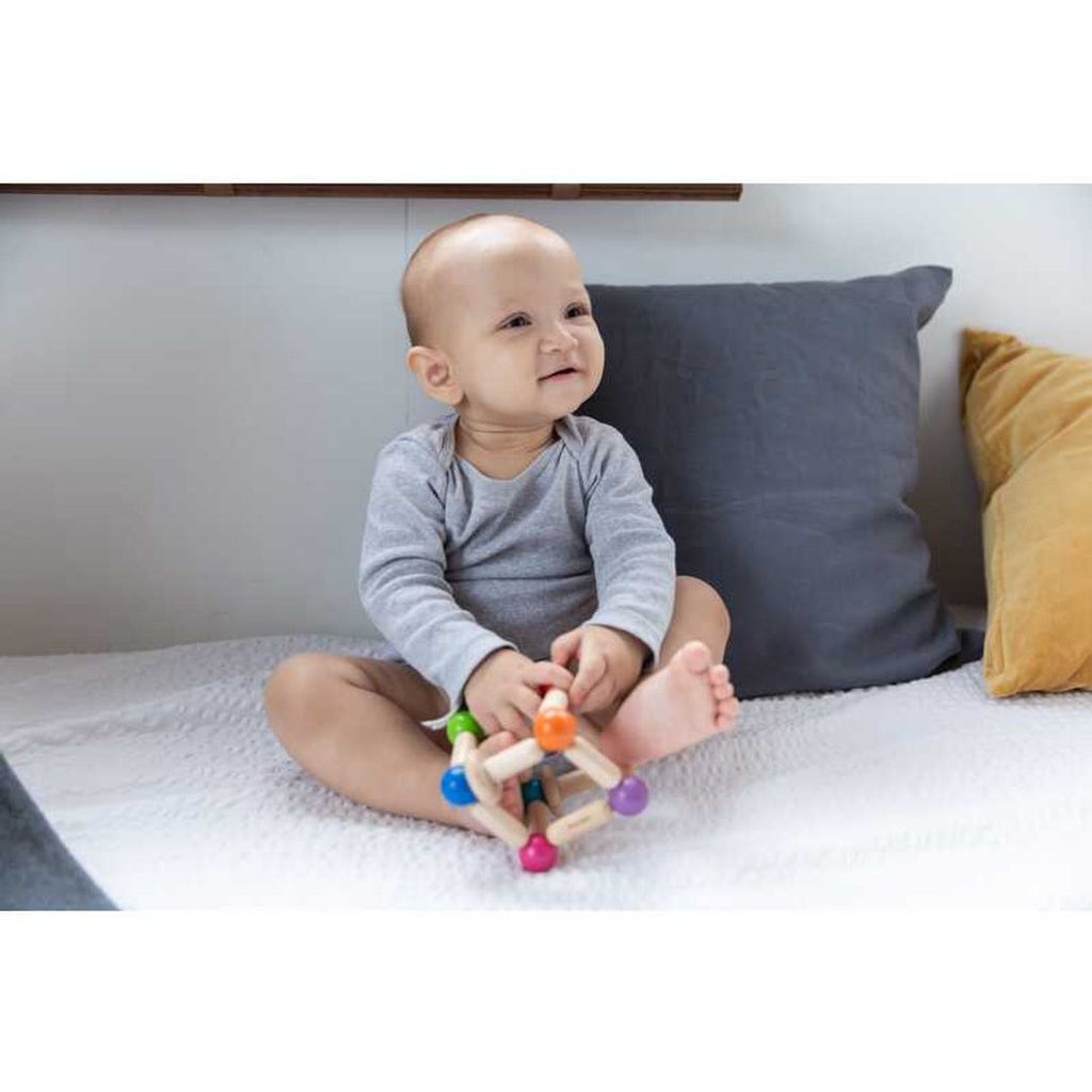 Kid playing PlanToys Square Clutching Toy