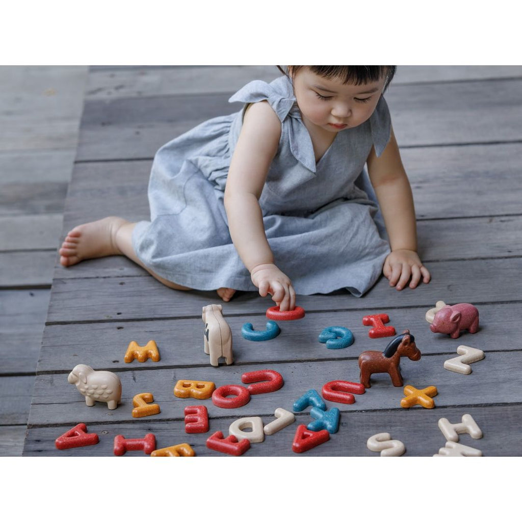 Kid playing PlanToys Upper Case Alphabet