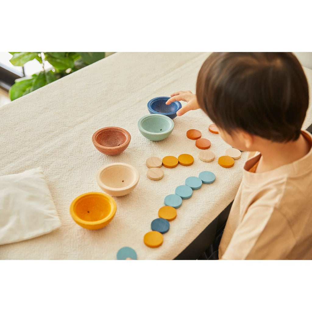 Kid playing PlanToys Sort & Count Cups - Orchard