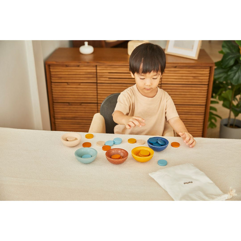 Kid playing PlanToys Sort & Count Cups - Orchard