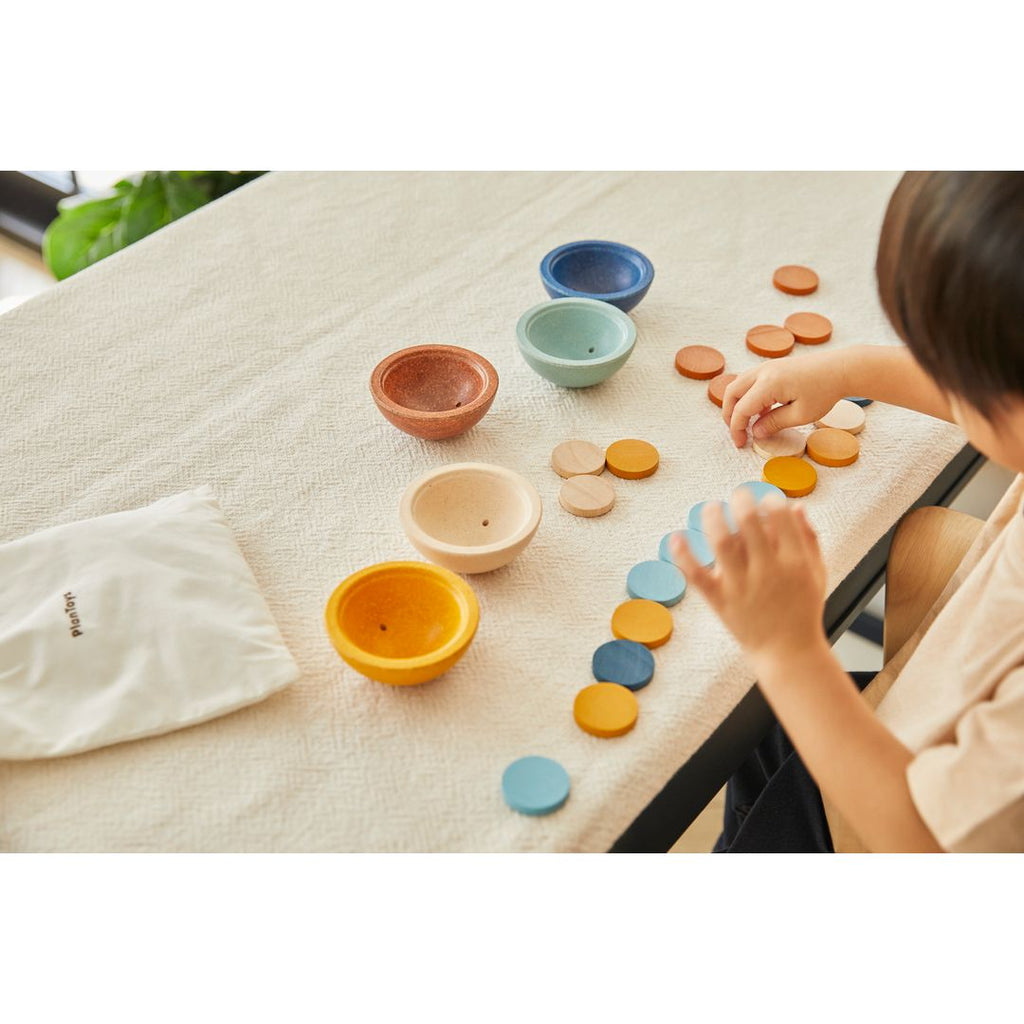 Kid playing PlanToys Sort & Count Cups - Orchard