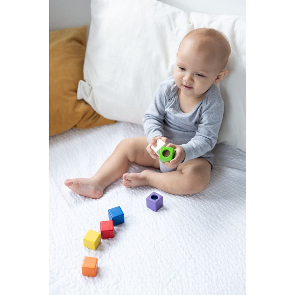 Kid playing PlanToys Activity Blocks