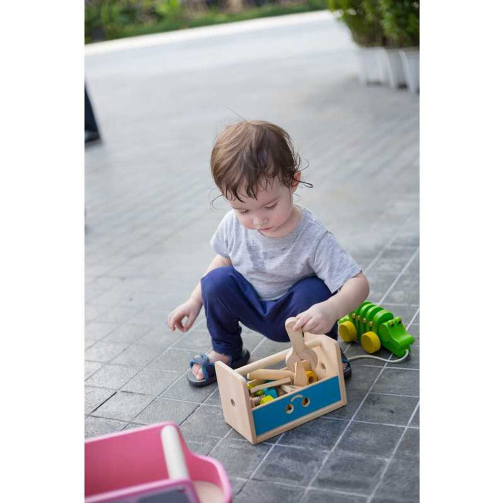 Kid playing PlanToys Robot Toolbox