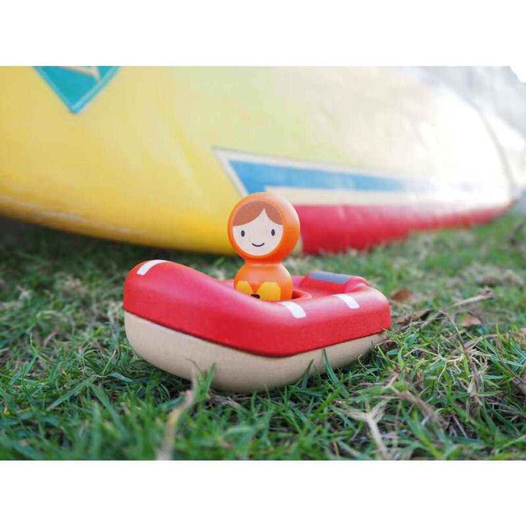 Kid playing PlanToys Coast Guard Boat