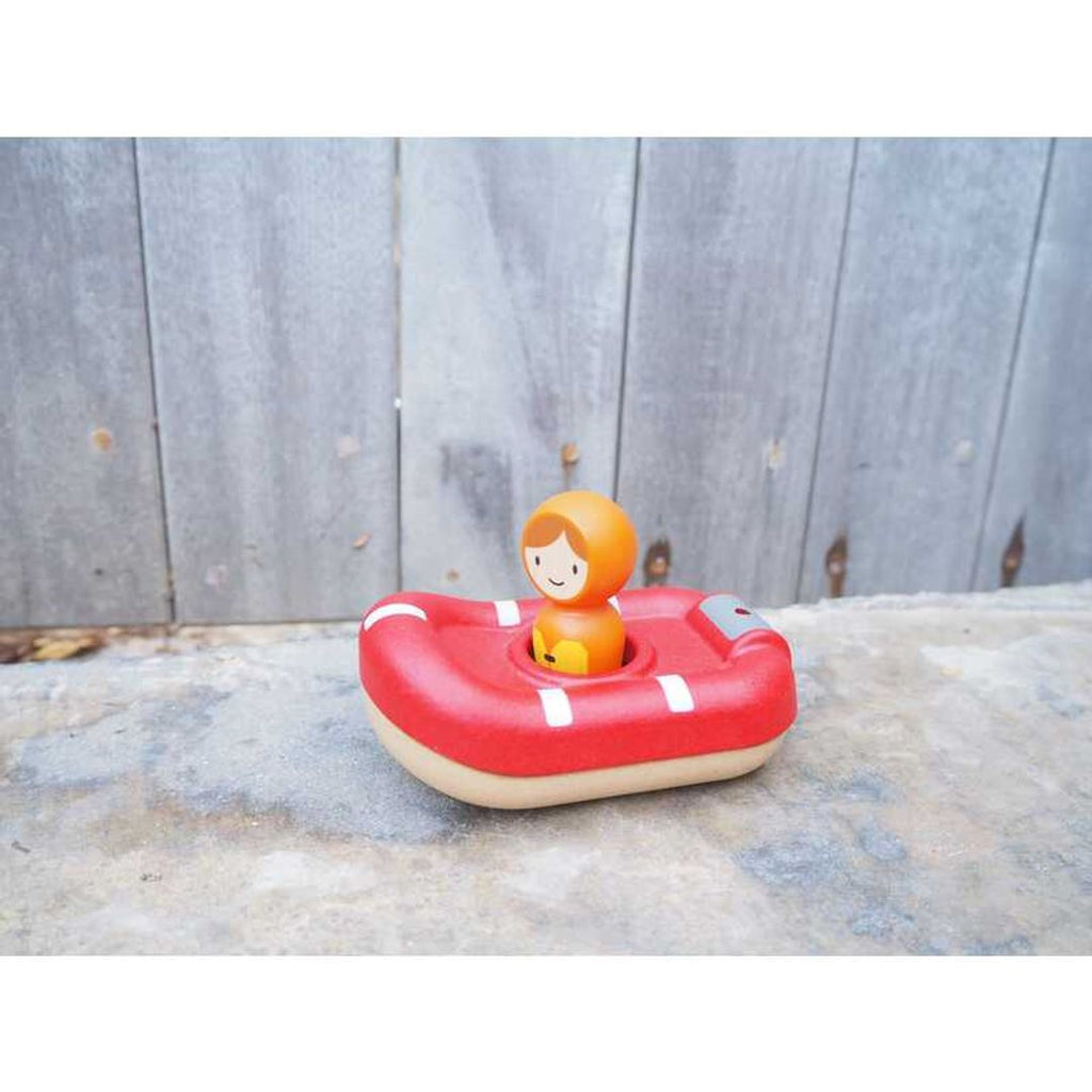 Kid playing PlanToys Coast Guard Boat