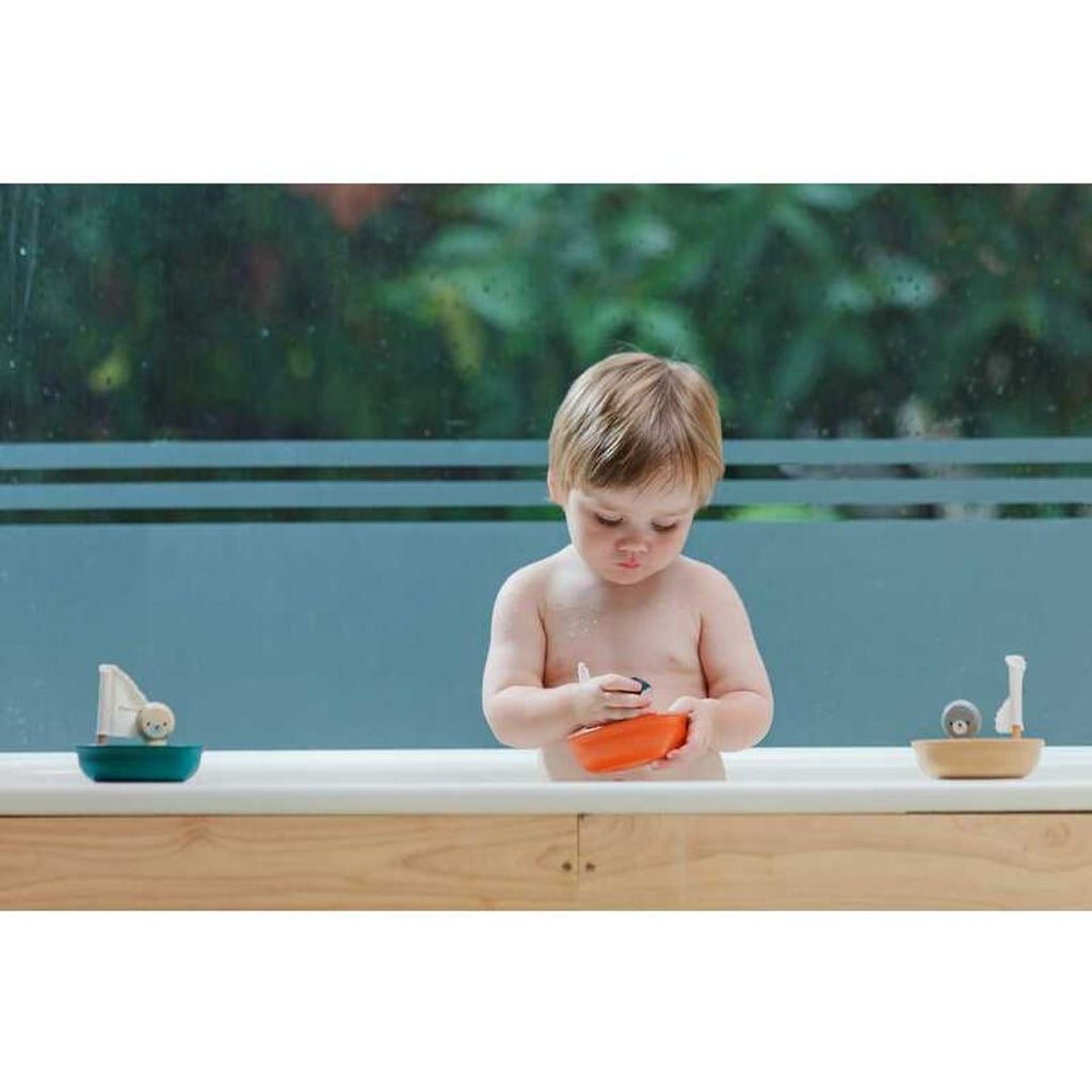 Kid playing PlanToys Sailing Boat - Penguin