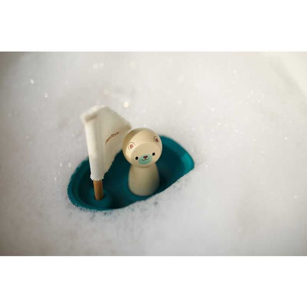 Kid playing PlanToys Sailing Boat - Polar Bear