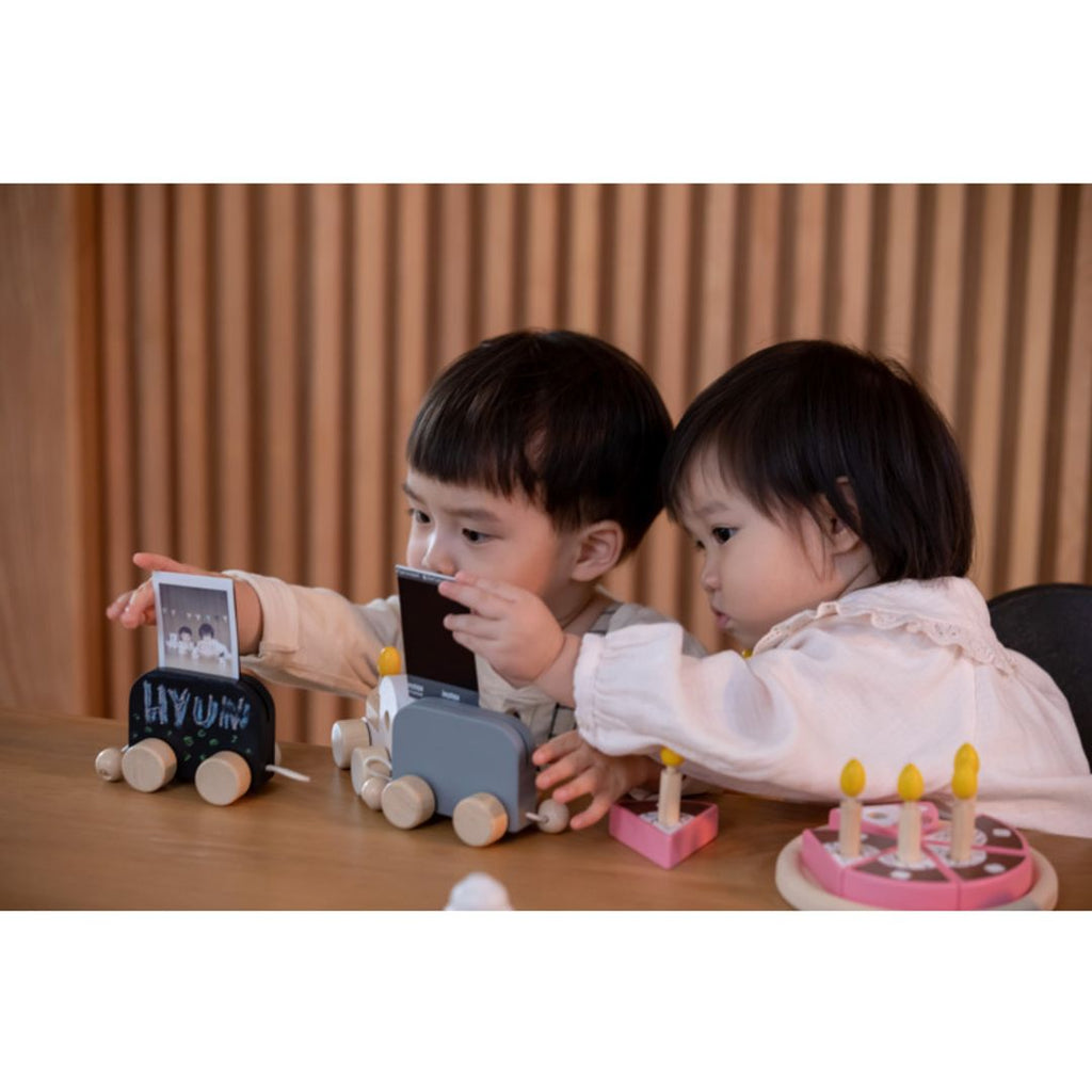 Kid playing PlanToys Celebration Train