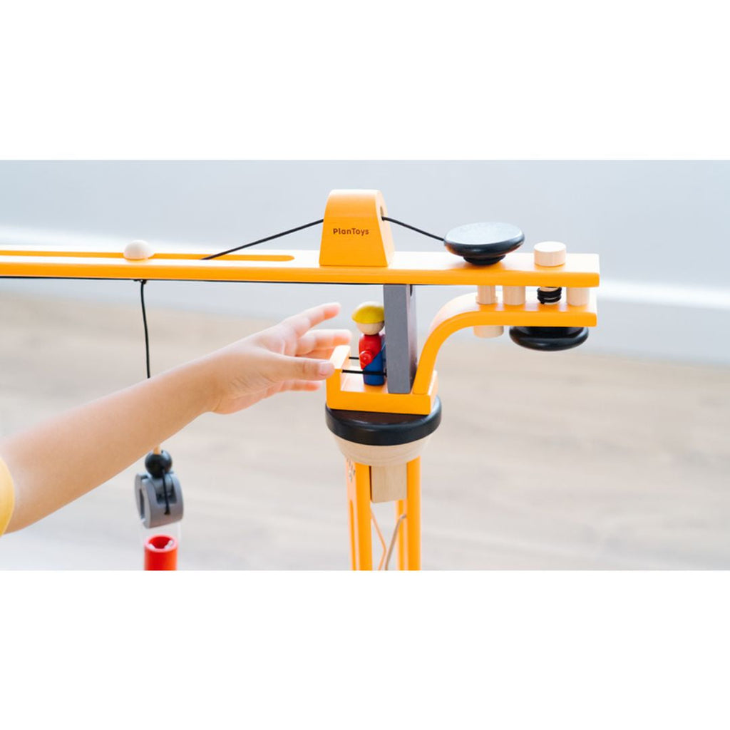 Kid playing PlanToys Crane Set