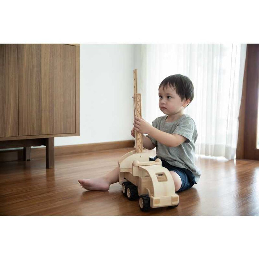 Kid playing PlanToys Fire Truck