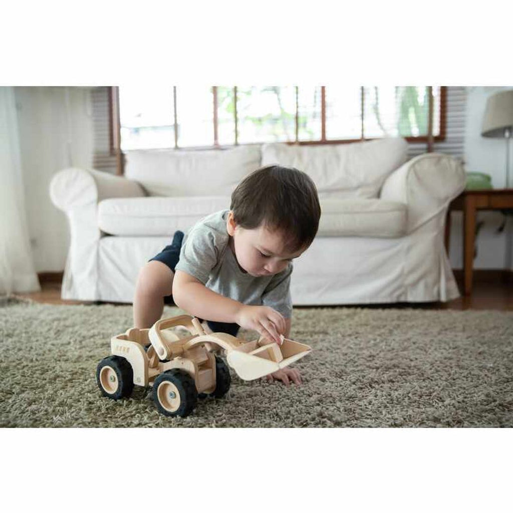 Kid playing PlanToys Bulldozer