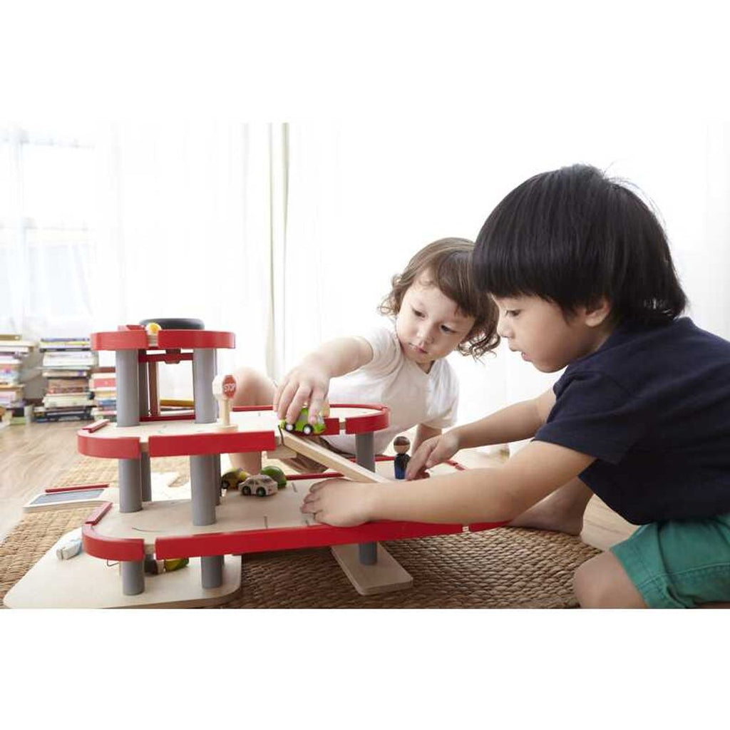 Kid playing PlanToys Parking Garage