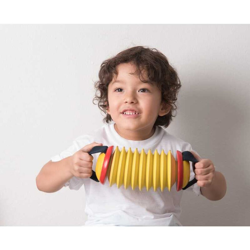 Kid playing PlanToys Concertina