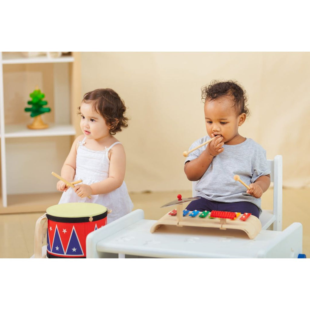 Kid playing PlanToys Musical Set