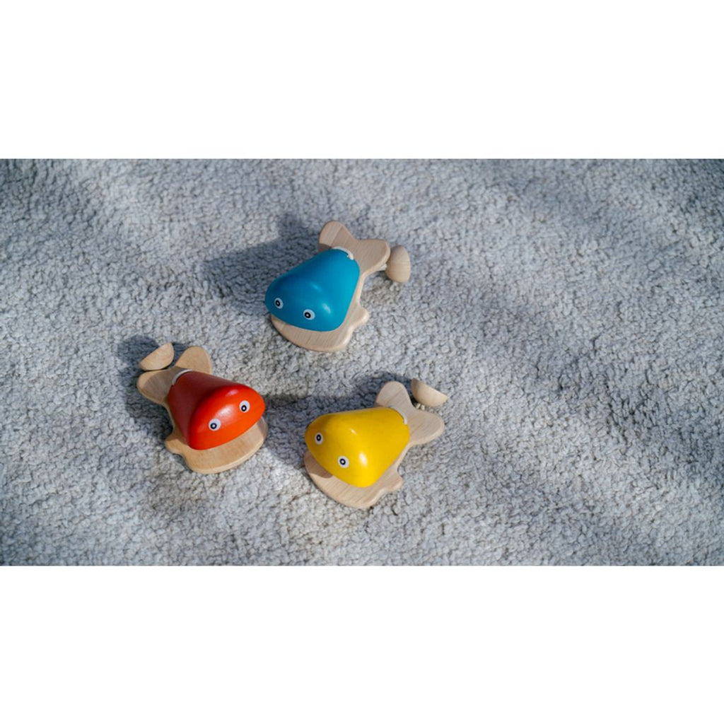 Kid playing PlanToys Fish Castanet