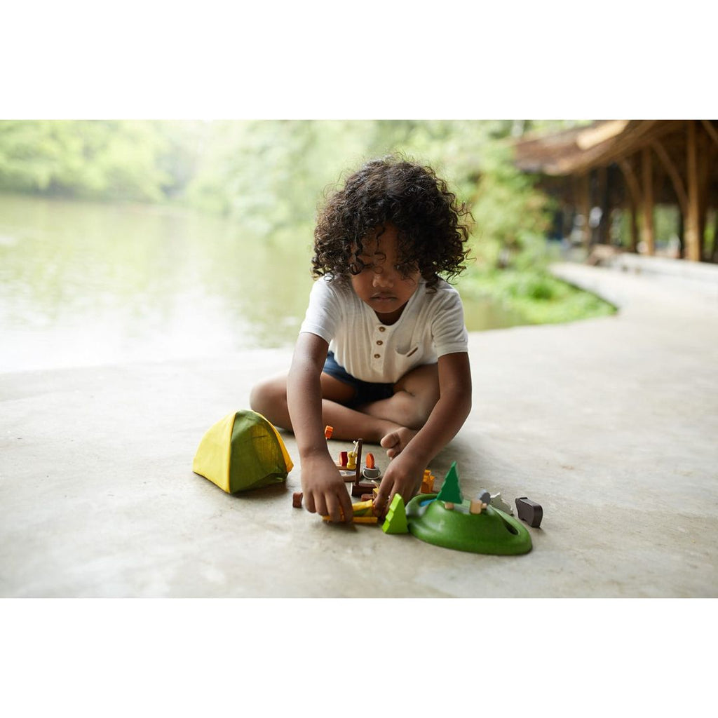 Kid playing PlanToys Camping Set