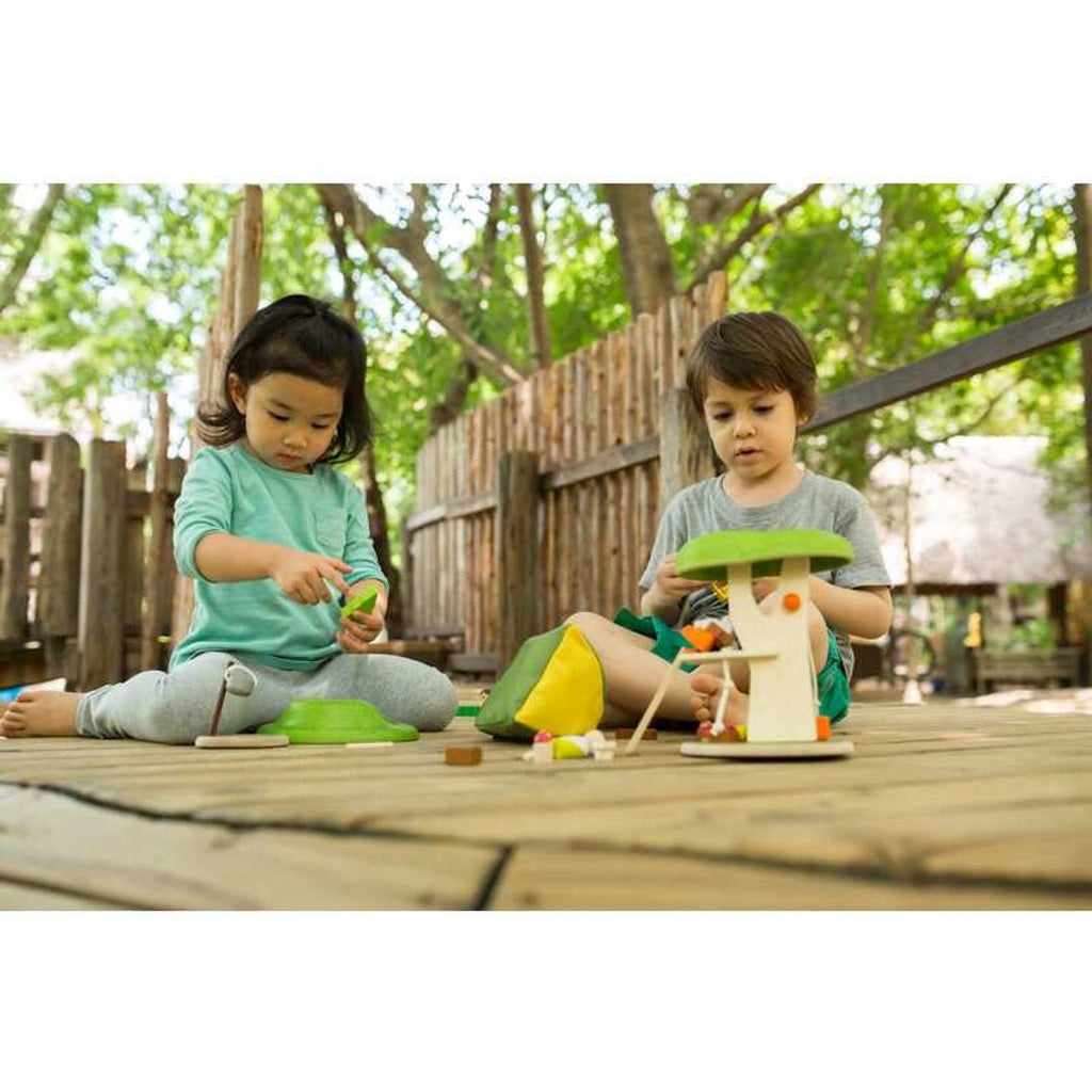 Kid playing PlanToys Tree House