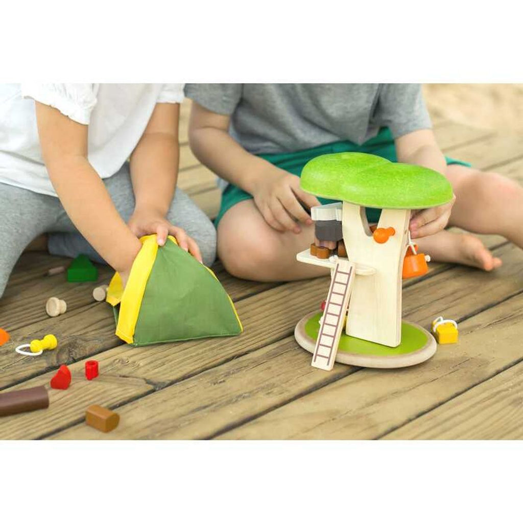 Kid playing PlanToys Tree House