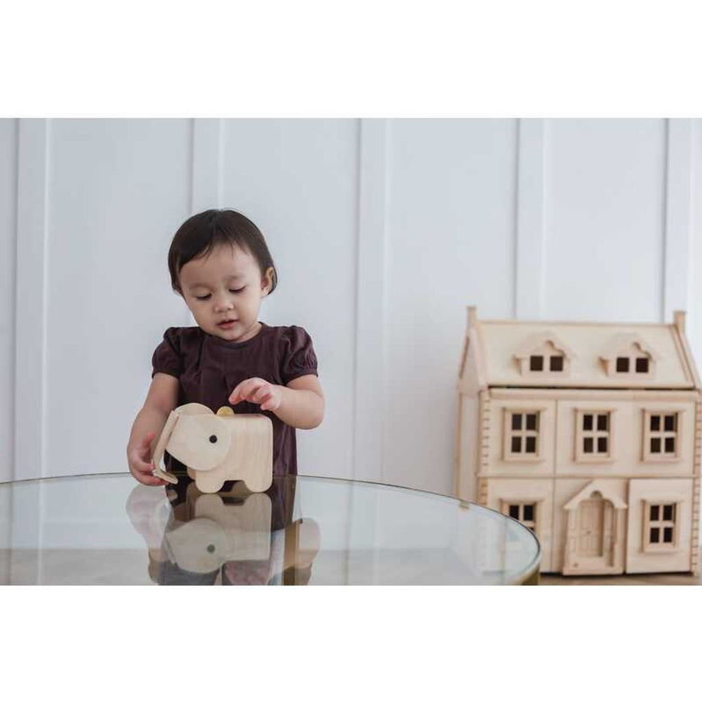 Kid using PlanToys Elephant Bank