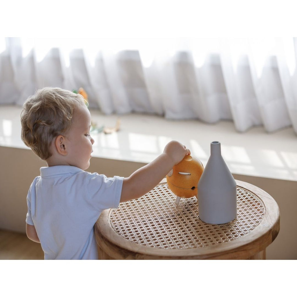 Kid using PlanToys Piggy Bank - Yellow