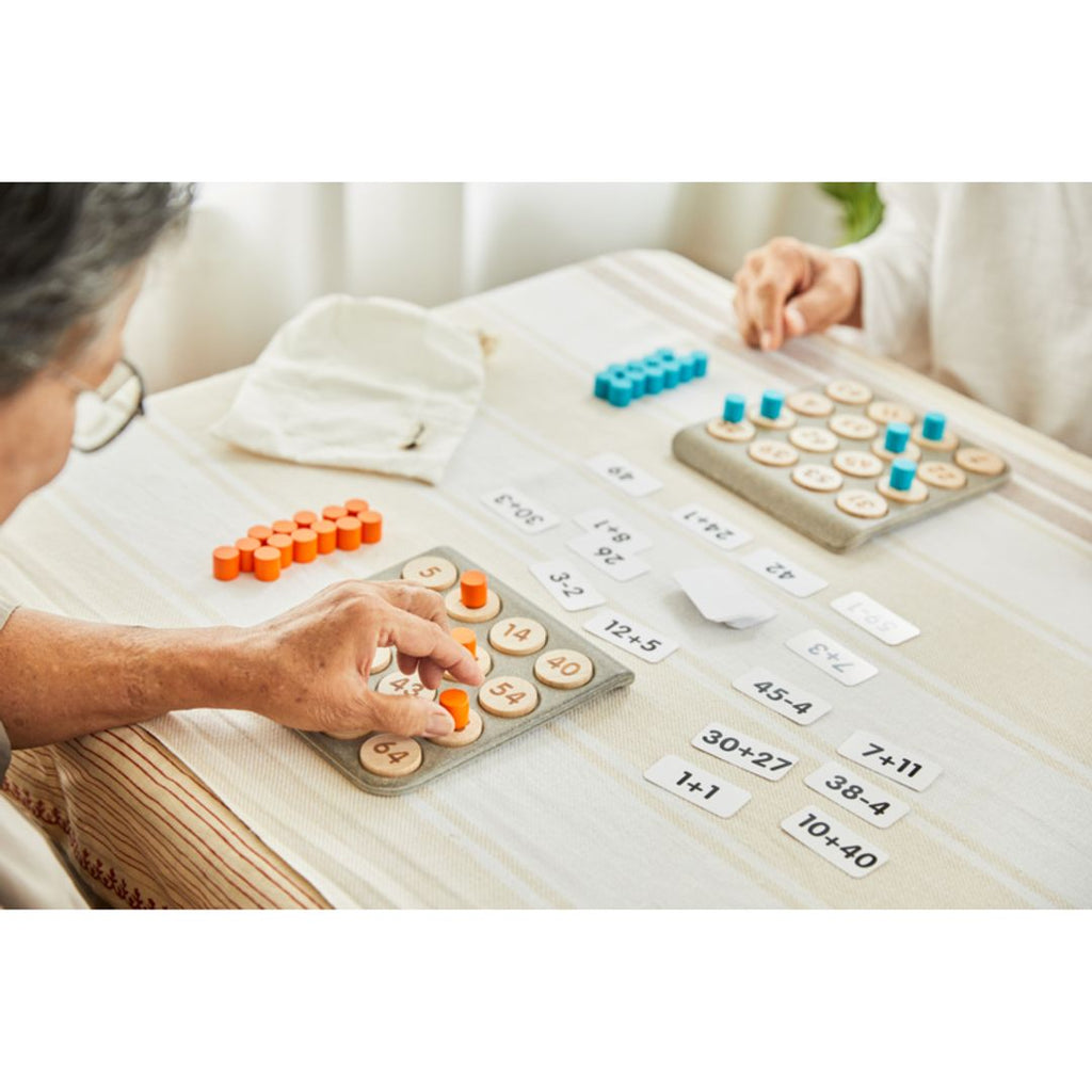 Elderly playing PlanToys Math Bingo